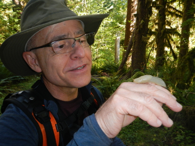Close up of a participant inquisitively checking out a small banana slug on his finger