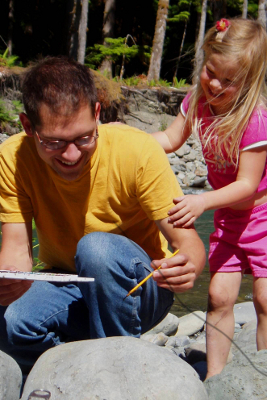 Older and younger naturalists painting with watercolors 