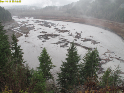 Photo showing the same river channel as the photo above two days later when very little land can be seen because the river is so bloated from flooding