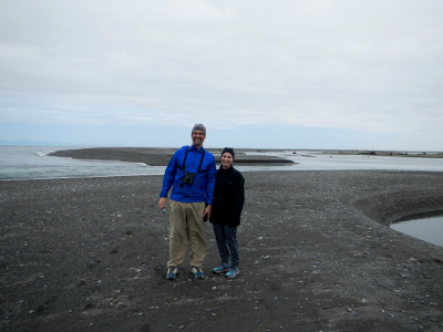 A couple stands on an expansive beach that has formed at the mouth of the Elwha River