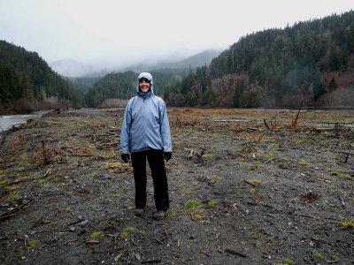 A person in a rain jacket and rain pants on the former delta of Lake Mills Reservoir