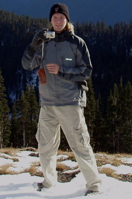 Olympic National Park hiker taking a photo with warm hat, synthetic jacket, and nylon hiking pants